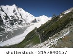 Great spring trip to Austria. Snow in May. The famous Grossglockner mountain road leads through flowering alpine meadows and snow-covered mountains. Hohe Tauern National Park. 