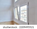 Window tilt open in a city apartment, letting in fresh air