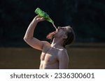 Small photo of Bearded man on the beach drinking beer pouring from high above like crazy, vehement action