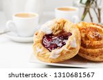 Romantic breakfast setup with Danish pastries and coffee