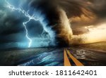 A dramatic and powerful tornado and supercell thunder storm passing through some isolated countryside at sunset. Mixed media landscape weather 3d illustration.