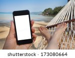 smartphone in the hand in beach hammock