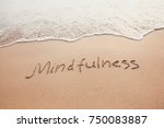 mindfulness concept, mindful living, text written on the sand of beach