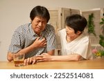 Small photo of Asian senior man having a palpitation of the heart at home