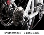Bicycle gears, disc brake and rear derailleur. Studio shot on black background