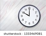 Small photo of Wall clock show ten o'clock on marble texture. Office clock show 10pm or 10am on marble texture with natural pattern