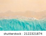 Aerial view of sandy beach and ocean nature with waves. Beach and waves from top view. Turquoise water background. Summer seascape from air. Aerial drone landscape. Travel vacation concept and idea