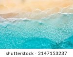 Relaxing aerial beach scene, summer vacation holiday template banner. Waves surf with amazing blue ocean lagoon, sea shore, coastline. Perfect aerial drone top view. Bright beach panorama, seaside