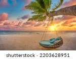 Small photo of Romantic beach sunset. Palm tree with swing hanging before majestic clouds sky. Dream nature landscape, tropical island paradise, couple destination. Love coast, closeup sea sand. Relax pristine beach