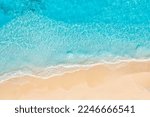 Summer seascape beautiful waves, blue sea water sunny day. Top drone view. Tranquil sea aerial amazing tropical nature Mediterranean. Beautiful bright sea waves splashing and beach sand sunset light