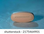 Small photo of Prednisone drug Pill Medication ob blue background