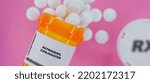 Small photo of Estrogens, Conjugated Rx medicine pills in plactic vial with tablets. Pills spilling from yellow container on pink background.
