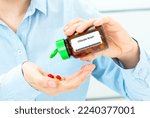 Small photo of Chlorate Anion Woman Hand holding on open palm with pill tablets medicine for healing