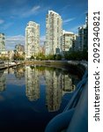 Small photo of Vancouver, British Columbia, Canada – May 6, 2018. Yaletown Vancouver Seawall Morning Towers. Morning sun reflects off Yaletown condominiums in downtown Vancouver. British Columbia, Canada.