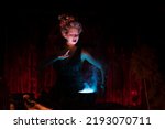 Small photo of Halloween witch with cauldron. Beautiful young woman conjuring, making witchcraft. Standing spooky dungeon dark room. Enchantress prepare love potion use magic spell