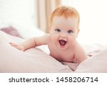 happy excited infant baby girl crawling on the bed