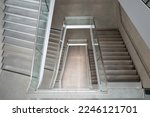Small photo of Interior diminishing perspective top view above hall or foyer between modern staircase.