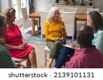 Small photo of Caucasian senior woman talking with multiracial people at group therapy session. unaltered, support, alternative therapy, community outreach, mental wellbeing and social gathering.