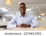Image of african american man having video call on laptop in office. Office, business, communication and technology concept.