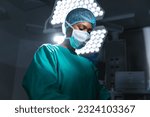 Small photo of African american female surgeon wearing surgical gown and face mask in operating theatre. Hospital, surgery, medicine, healthcare and work, unaltered.