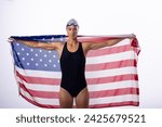 Small photo of Female swimmer in a swimsuit holds an American flag. Pride and patriotism emanate from the female swimmer's confident pose.