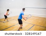 Couple enjoying a game of squash in the squash court