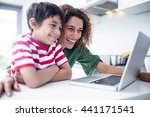 Mother And Son Using Laptop In...