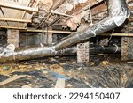 Small photo of Crawl Space under house with air conditioner ductwork and insulation