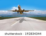 White Passenger plane fly up over take-off runway from airport - Commercial passenger airplane takes off from the runway