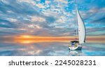 Small photo of Lonely yacht sailing in the Mediterranean sea at amazing sunset - Sailing luxury yacht with white sails in the Sea.