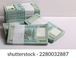 Small photo of Stacks of Lebanese pounds, 100,000 denomination, symbolizing the downfall of the Lebanese currency.