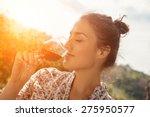 Beautiful Young Woman Drinking Wine In Vineyard