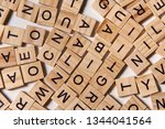 Background of wooden alphabet letters scattered randomly on white background