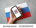 hand with mobile phone with crossed out swift symbol on russian flag background, swift shutdown in Russia banks. War between Ukraine and Russia, Russian aggression, February 2022. Top view
