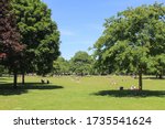 Small photo of Victoria Park, London / UK - May 19 2020: Sunbathers in a large park in the Borough of Tower Hamlets in East London
