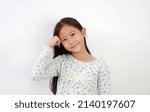 Small photo of Portrait of smiling Asian young girl put stranglehold on head with looking at camera on white background.