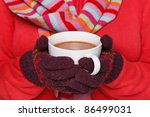Small photo of Close up midriff photo of a woman wearing a red jumper, woolen gloves and a scarf holding a mug full of hot chocolate, good image to convey a feeling of winter and warmth.