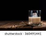 Glass with original Irish Cream Liqueuron wooden background