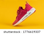 Running sports shoe on yellow background. Running shoe, sneaker or trainer. Women's athletic shoe. fitness, sport, training concept.