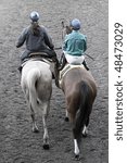 Small photo of ARCADIA, CA - 10 MAR: Jockey Michael Baze and "T.D. Vance" are guided through the tunnel to the starting gate by an outrider and her pony at Santa Anita Park on Mar 10, 2010, in Arcadia, CA.