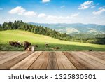 Cow pasture in rural mountains, product display or montage on wooden boards.