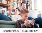 Family with laptop, tablet and smartphone at home, everyone using digital devices