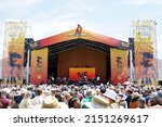 Small photo of New Orleans, LA United States - April 30, 2022: Crowds at the 2022 New Orleans Jazz and Heritage Festival on the "Festival Stage" dance to funk legend Big Sam's Funky Nation.