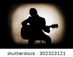Silhouette of guitarist in...