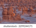 Small photo of The rays of the setting sun illuminate goblins in Goblin Valley State Park, Utah.