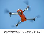 Small photo of LENINGRAD REGION, RUSSIA - MAY 30, 2021: Autel Robotics EVO II quadcopter hovering overhead in a blue cloudless sky
