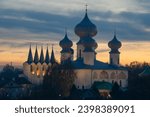 Small photo of Belfry and domes of the ancient Assumption Cathedral on a October twilight. Tikhvinsky Assumption Monastery. Tikhvin, Russia
