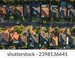 Top down aerial view of a neighbourhood street lined with upmarket houses in outer suburban Sydney, Australia.