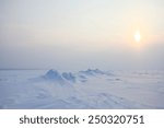Plain of snow, ice and low Northern sun