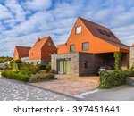 Modern architecture houses with remarkable red roof tiles in a contemporary suburban neighborhood in the Netherlands